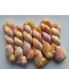 Variegated skeins in sherbet pinks, oranges and cream.