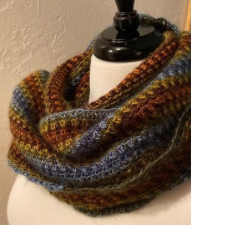 Infinity cowl knit horizontally in a warm variegated yarn.