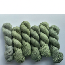 Several skeins of semi-solid medium sage green.