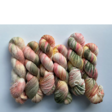 Variegated skeins in deep sage, pinks and white.