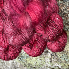 Deep fuchsia tonal yarn on a variety of bases.