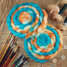 Two braids of roving in bright aqua, pumpkin orange and white.