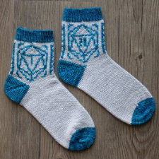 Socks with contrasting cuff, heel and toe, and colorwork of 20-sided dice on the leg.