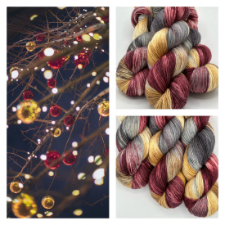 Photograph of bare tree branches at night, hung with gold and deep red glass ornaments. Three skeins of maroon, gold and gray-brown variegated yarn.