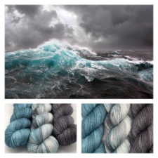 Photo of dark sky and rough waves, with three skein set of deep gray, white and shades of gray, and tonal aqua.