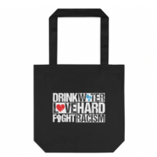 Black tote says in all caps “Drink water. Love Hard. Fight Racism