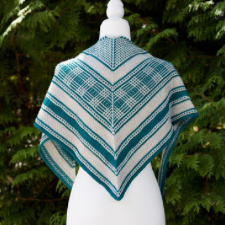 Two-color mosaic triangular scarf knit on the bias has elements of a gingham picnic cloth.