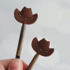 Brown cowboy hat shaped needle stops