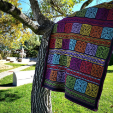 Mosaic crochet blanket in alternating rows of squares and strips. Squares resemble hand-painted Moroccan tile.