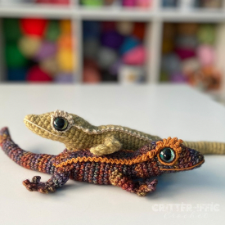 Two crocheted geckos, one light, one dark.
