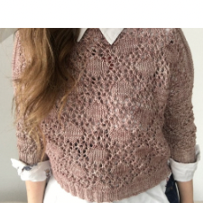 Pullover with stockinette diamonds bordered by lace. Three-quarter length sleeves. Cuffs and hem are ribbed.