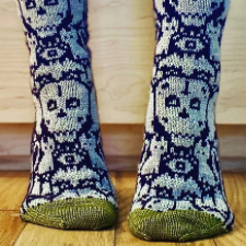 Colorwork socks feature large skulls, all-seeing eye, cats, bats and more.