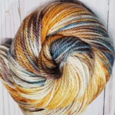 Cream and caramel color yarn with touches of dusty blue and brown.