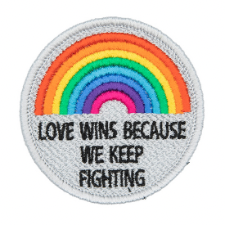 Patch has rainbow and reads, Love wins because we keep fighting.