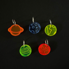 Stitch markers in fluorescent perspex are in the shape of Jupiter, Venus, Saturn, Earth and our moon.