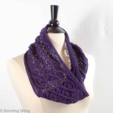 Impossibly delicate diagonal cable and lace worsted cowl in deep purple.