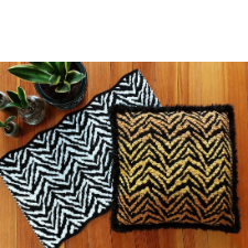 Zebra and tiger stripe patterns, shown on a table runner and pillow. A wall hanging is also available