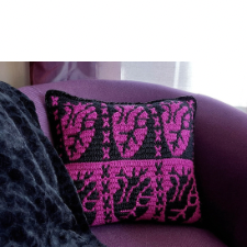 Pillow features anatomical hearts with arteries and veins. Top of the pillow has three motifs. Bottom has three, with the colors reversed.