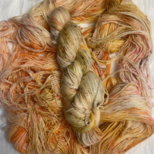Speckled yarn in colors from softest gold to pale orange.