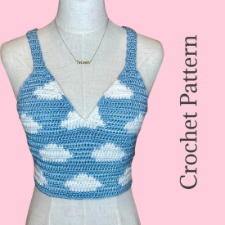 Sky blue tank with multiple strap crossings in back has white cloud motif.