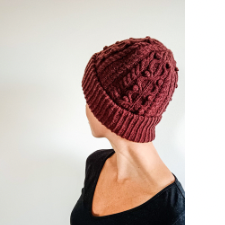 Cabled and bobbled beanie with foldup ribbed brim.