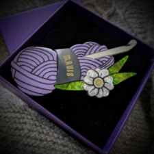 Acrylic brooch of skein and crochet hook plus tropical flower looks like vintage bakelite and mother of pearl.