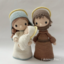 Crocheted Mary and Joseph, holding swaddled Jesus.