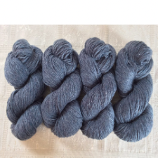 Slate blue skeins of mule-spun yarn.