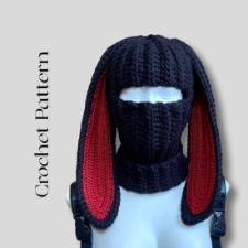 Dark balaclava with ears that extend a few inches past the shoulders. Ears are lined in red yarn.