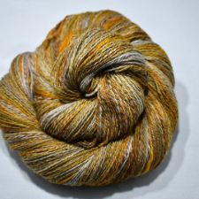 Variegated yarn with a bit of marling, in antique gold, brown, orange and gray.