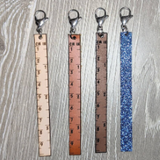 A clip-on nine-centimeter, three and a half-inch leather ruler with optional glitter backing.