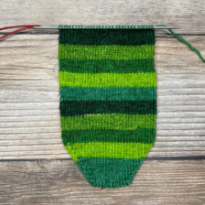 Striped yarn in five shades of green.