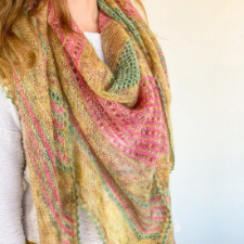 Laceweight shawl with solid and lacy sections, shown in gold with pink and green accents.