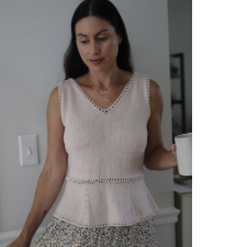 V-neck top with flared peplum bottom. Neckline and start of flare are set off with a few rows of openwork.