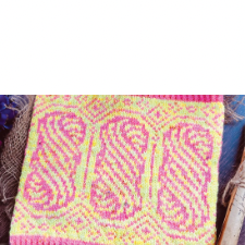 Three large twisted hanks dominate each side of this cowl, with geometric shapes filling in the gaps. Design is pink on yellow.