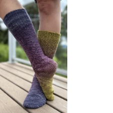 Knee socks with elegant textured curves, shown in gradient yarn.