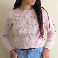 Textured sweater has kite shapes in mitered stockinette or traveling cables that form ribbing