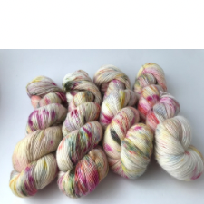 Variegated yarn on a cream base with bright pink, yellow and green splashes.