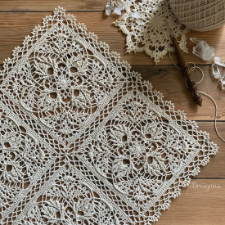 Square doily pattern, shown with four squares joined. Beautiful leafy openwork. The four squares are joined with lattice and embellished around the outside edge.