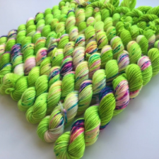 Bright yellow green base color with splashes of true blue, red, aqua, yellow and lighter green.