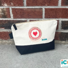Zippered cotton flat-bottom project bag. Top is white with red heart with rainbow scribbled circle around it. Bottom of the bag and zipper pull are black.