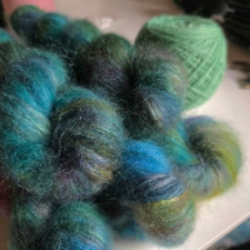 Lace-weight kid-silk mohair in moss greens, aqua, magenta and purple.