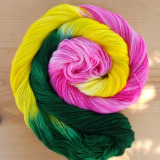 Variegated yarn in longer dye areas of deep green, bright yellow and tonal deep pink.