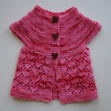 Short-sleeve raglan baby cardigan has three heart-shape buttons in the stockinette top. The lower part of the sweater is lace in a heart pattern.