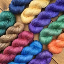 10 skeins of shiny solid color yarn.